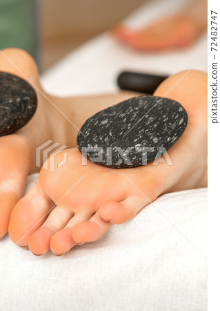 Massage stones on soles feet Massage stones on soles feet 72482747