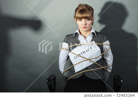 Upset businesswoman bound by contract terms. Upset businesswoman bound by contract terms. 72483164