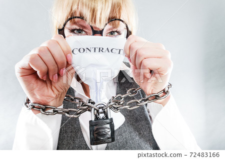 Furious woman with chained hands and contract 72483166