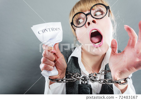 Furious woman with chained hands and contract Furious woman with chained hands and contract 72483167