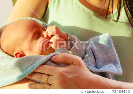 Little newborn baby sleeping calmly in blanket Little newborn baby sleeping calmly in blanket 72484400