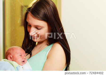 Mom with newborn baby in her arms Mom with newborn baby in her arms 72484402