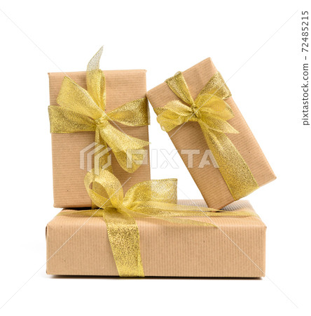 stack of gifts wrapped in brown kraft paper and tied with silk ribbon, boxes isolated on white background stack of gifts wrapped in brown kraft paper and tied with silk ribbon, boxes isolated on white background 72485215