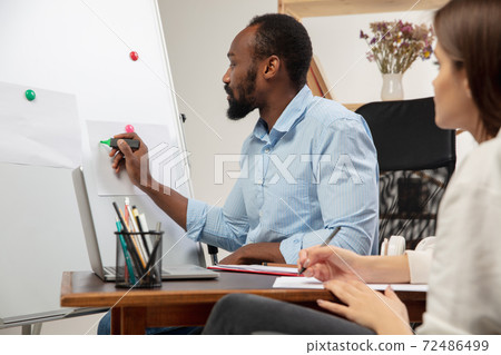 English courses at home. Smiling man teaches student in interior of living room 72486499