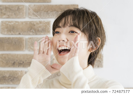 Young woman cheering out loud Young woman cheering out loud 72487577