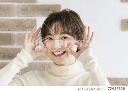 Young woman making "OK" sign 72488836
