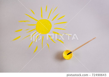 yellow sun drawn on gray paper. yellow sun drawn on gray paper. 72490643