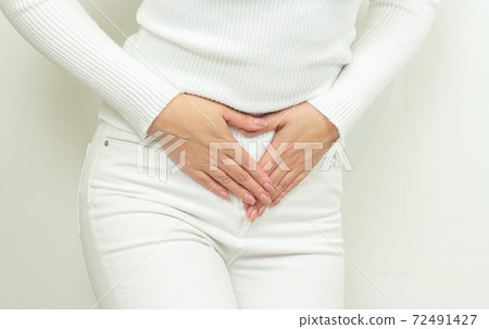 Abdominal pain of young woman, gynecological or medical problems concept 72491427