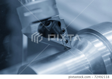 Close-up scene  CNC lathe machine thread cutting the metal shaft part. 72492118