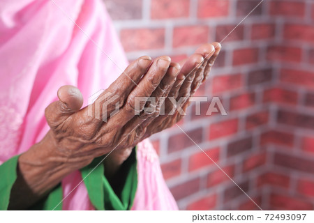 Close up of senior women hand praying at ramadan Close up of senior women hand praying at ramadan 72493097