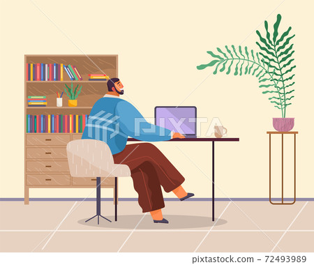 Office worker sits at table, works at laptop, cup, bookcase, folders, potted plant. Cozy office 72493989