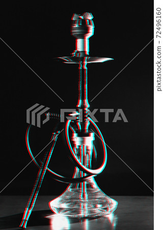 Hookah with a glass flask on the table in a restaurant 72496160