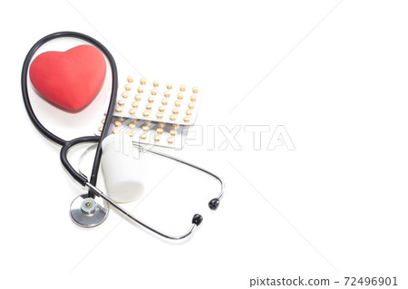 Red heart on the background of pills. Concept of health, heart disease. Red heart on the background of pills. Concept of health, heart disease. 72496901