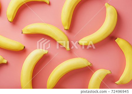 Bright pattern of yellow bananas on a pink background. Bright pattern of yellow bananas on a pink background. 72496945
