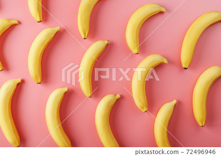 Bright pattern of yellow bananas on a pink background. Bright pattern of yellow bananas on a pink background. 72496946