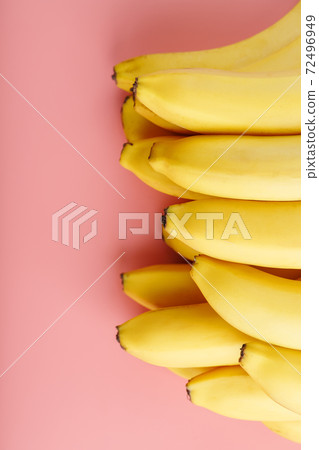 Fresh bunch of yellow bananas isolated on a pink background. Fresh bunch of yellow bananas isolated on a pink background. 72496949