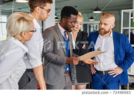 side view on confident afro american leader of team talking with employees 72496983