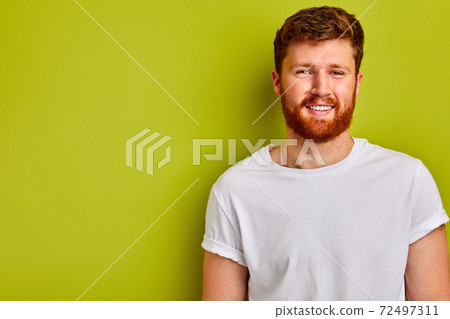 young caucasian guy in casual t-shirt smiling at camera young caucasian guy in casual t-shirt smiling at camera 72497311