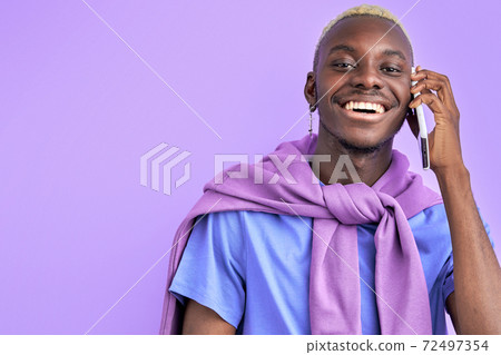 afro american guy in colourful casual wear talk on phone 72497354