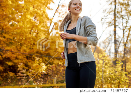 caucasian attractive woman running in the forest 72497767