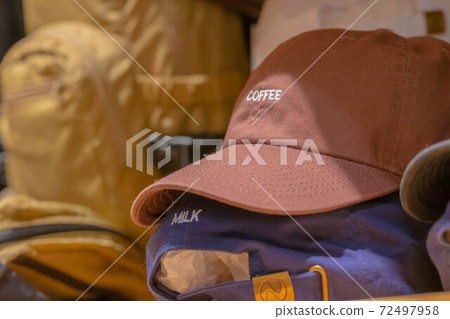 Display of hats with embroidered letters 72497958