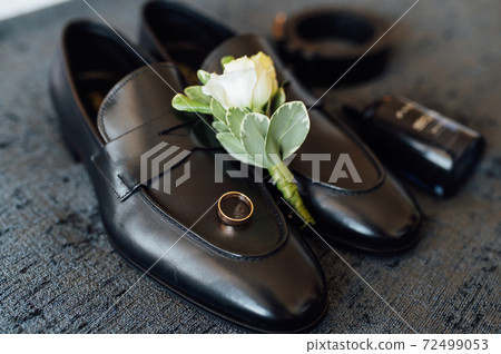 Wedding morning. The groom accessories lie on the gray bedspread 72499053