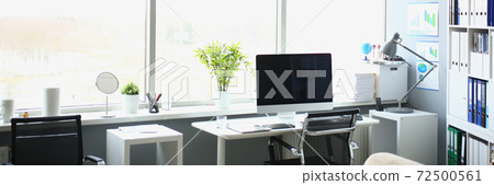 Interior of workplace with table, computer and large window Interior of workplace with table, computer and large window 72500561