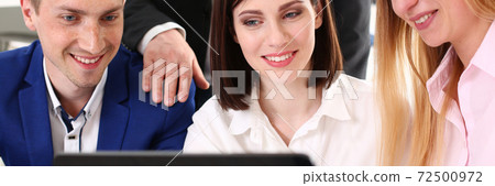 Cheerful office workers using digital tablet computer in office Cheerful office workers using digital tablet computer in office 72500972