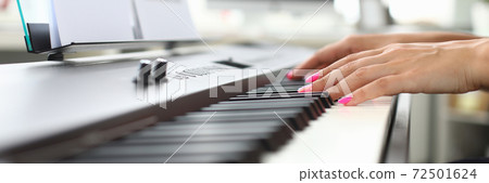 Young woman hands playing piano at home Young woman hands playing piano at home 72501624