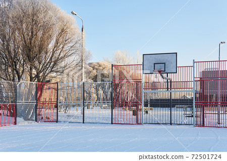public outdoor basketball court on a frosty winter day 72501724