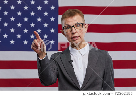 Mature Female Leader against American Flag 72502195