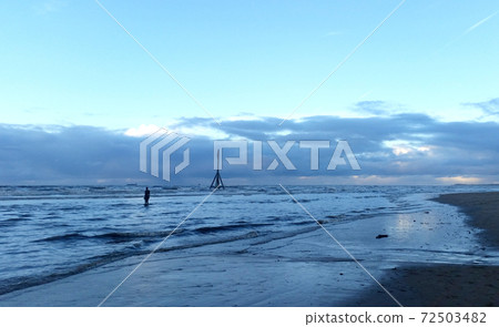 Sunset on Crosby Beach in winter, Crosby, Liverpool, United Kingdom 72503482