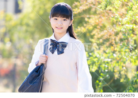 Junior high school girls in uniforms going to school Junior high school girls in uniforms going to school 72504070