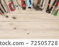 Top view variety of tools desk light brown wood   with copy space, Top angle many different tools for carpenter and building on wooden table with workplace, Technician repair concepts background. 72505728