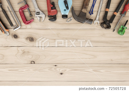Top view variety of tools desk light brown wood with copy space, Top angle many different tools for carpenter and building on wooden table with workplace, Technician repair concepts background. Top view variety of tools desk light brown wood with copy space, Top angle many different tools for carpenter and building on wooden table with workplace, Technician repair concepts background. 72505728