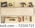 Top view variety of tools desk light brown wood   with copy space, Top angle many different tools for carpenter and building on wooden table with workplace, Technician repair concepts background. 72505735