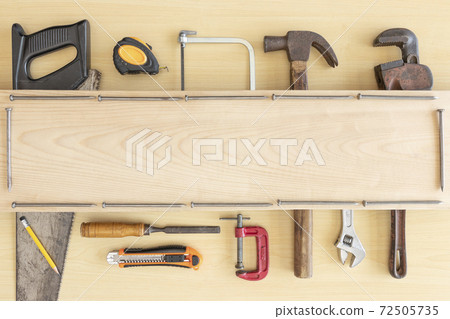 Top view variety of tools desk light brown wood with copy space, Top angle many different tools for carpenter and building on wooden table with workplace, Technician repair concepts background. Top view variety of tools desk light brown wood with copy space, Top angle many different tools for carpenter and building on wooden table with workplace, Technician repair concepts background. 72505735