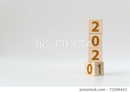New year 2020 change to 2021 concept. Wooden cube block flip over change years New year 2020 change to 2021 concept. Wooden cube block flip over change years 72506423