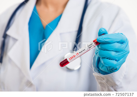Doctor scientist in white uniform wear a mask holding test tube Coronavirus 72507137