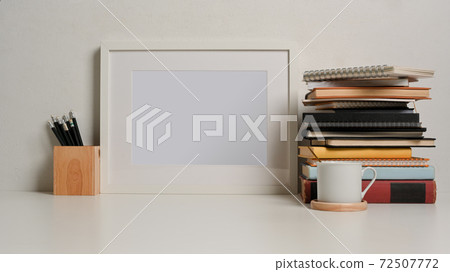Study table with mock up frame, stack of books, pencils and copy space 72507772