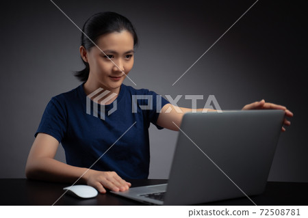 Asian woman working with laptop. Asian woman working with laptop. 72508781
