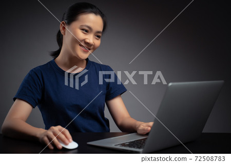 Asian woman working with laptop. Asian woman working with laptop. 72508783