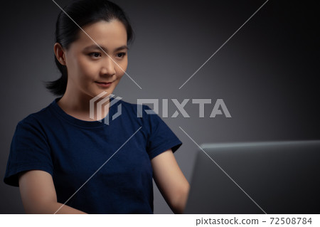 Asian woman working with laptop. Asian woman working with laptop. 72508784