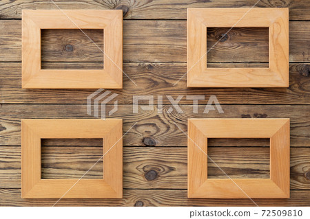 Four wooden frame or photo frame over wooden background, copy space, design and home interior. Four wooden frame or photo frame over wooden background, copy space, design and home interior. 72509810