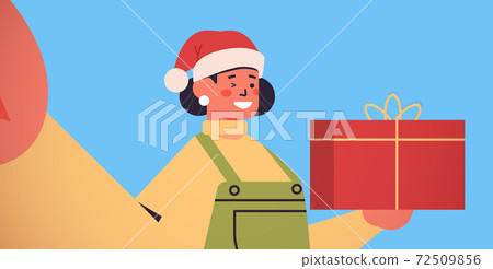 happy woman in santa hat with gift box holding... - Stock Illustration ...