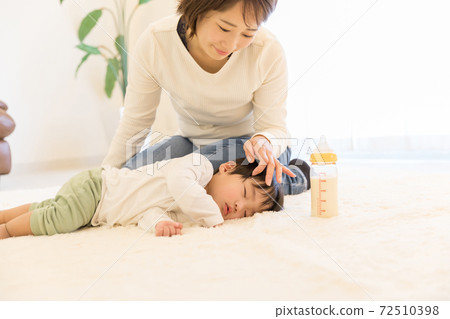A baby who has been sleeping while breastfeeding A baby who has been sleeping while breastfeeding 72510398