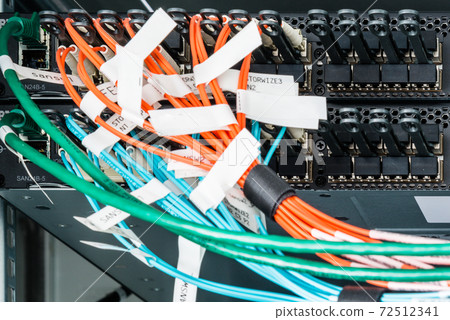 Fiber Optic cables connected to an optic ports 72512341