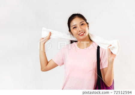Portrait young pretty woman in pink t-shirt carrying yoga mat wipe the sweat on face after exercise looking camera posing on the white background 72512594