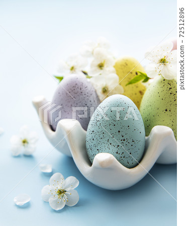 Easter eggs in egg tray and spring blossom Easter eggs in egg tray and spring blossom 72512896