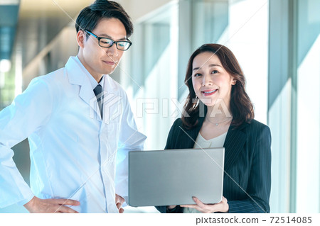 一套西裝的女MR與一名醫生在醫院的白色長袍會議 一套西裝的女MR與一名醫生在醫院的白色長袍會議 72514085
